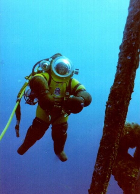 Deep-sea diver exploring underwater wreckage.