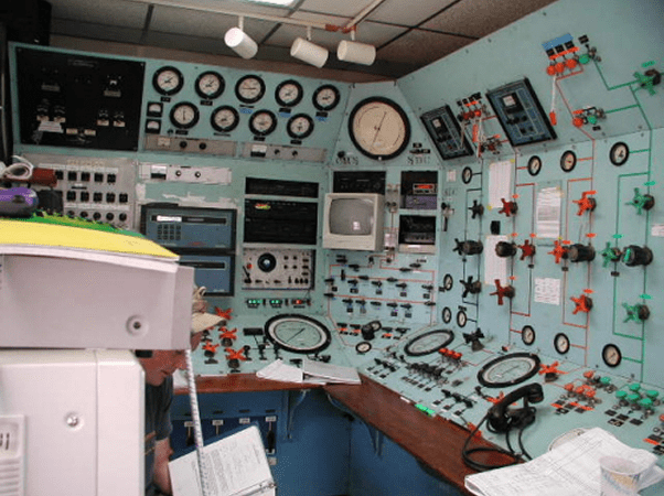 Control room with various dials and gauges.