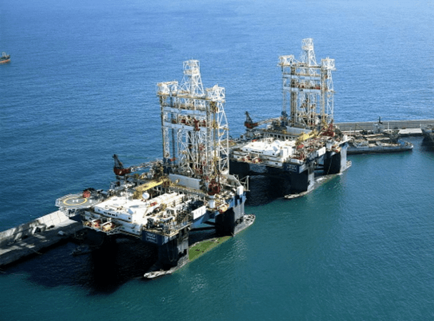 Two offshore oil rigs in the ocean.