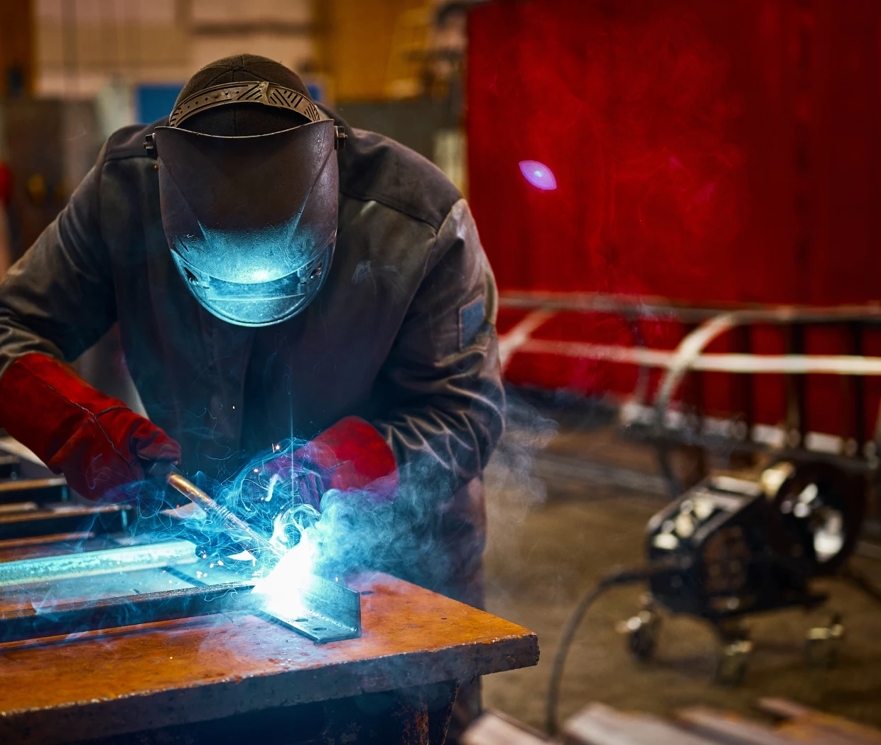 Welder working with bright blue sparks.